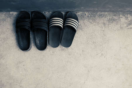 Black sandals on cement floorの写真素材