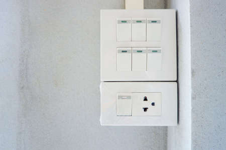 Switches and power outlets mounted on the wall.