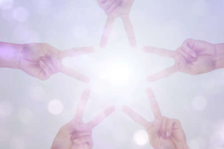 create idea of hand is star shape with white sun light on bokeh backgroundの写真素材
