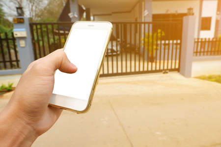 hand is hold smartphone with white screen for call To call someone in the house To come out to open...