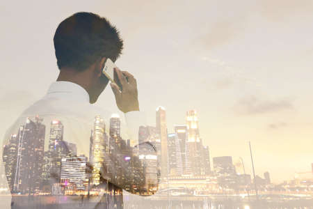 Businessman talking on the phone To prepare for investment in the city