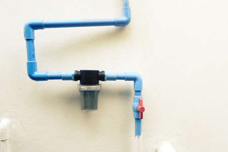 Installing valves and water filters on the wall before entering the house