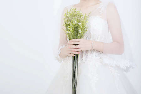 Fashion of bridal dress with flowers on studio backgroundの写真素材