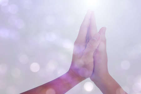 man and woman are use palm Touch each other with white sunlight isolated on bokeh backgroundの写真素材