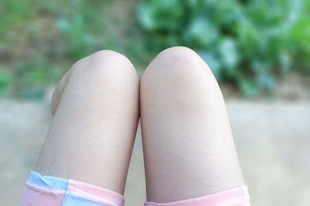 close up leg of woman in sit gesture in garden for relaxの写真素材