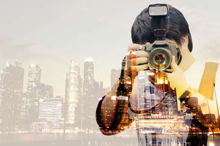 Photographer is picking up a camera and take a picture.He likes to take pictures in the city. because fun and very work with double exposure concept idea.の写真素材