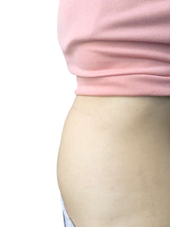 The appearance of the belly of woman At the start of pregnancy isolated on white backgroundの写真素材