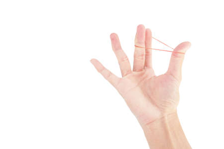Plastic rubber band in hand with finger exercise on white backgroundの写真素材
