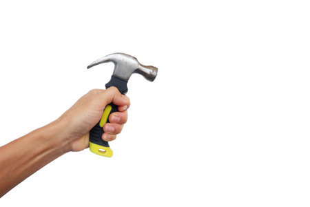 A man's hands are holding tools such as a hammer and screwdriver.の写真素材