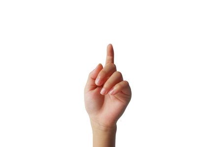 A small child's hand is making a gesture showing his hand up on a white background.の写真素材