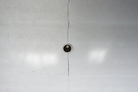 Cracked gypsum ceiling with downlights