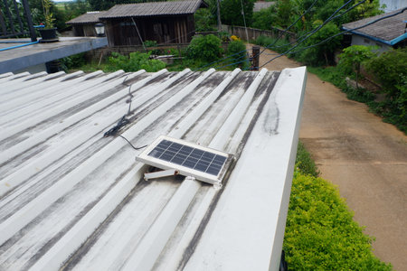 Small solar panels installed on a metal sheet roofの写真素材