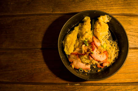 Chinese noodles with pork and shrimp on the wood texture, it very delicious.の写真素材