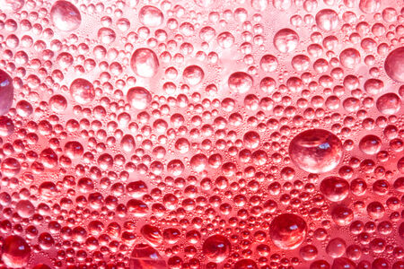 the red water drop closeup for backgroundの写真素材