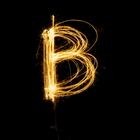 Sparkler firework light alphabet B with uppercase isolated on black background.の写真素材