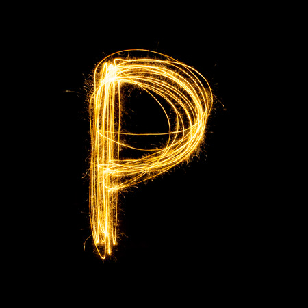 Sparkler firework light alphabet P with uppercase isolated on black background.の写真素材