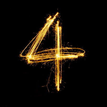Sparkler firework light alphabet number 4 isolated on black background.の写真素材