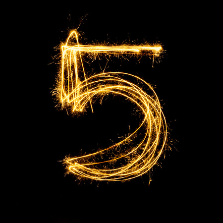Sparkler firework light alphabet number 5 isolated on black background.の写真素材
