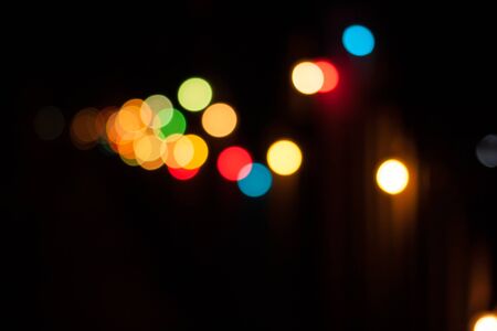 Colorful defocused bokeh lights background. Festive background with natural bokeh. Abstract blur background.の写真素材