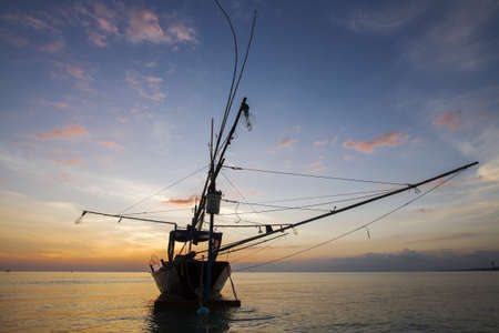 A Fisher boat on sunsetの写真素材