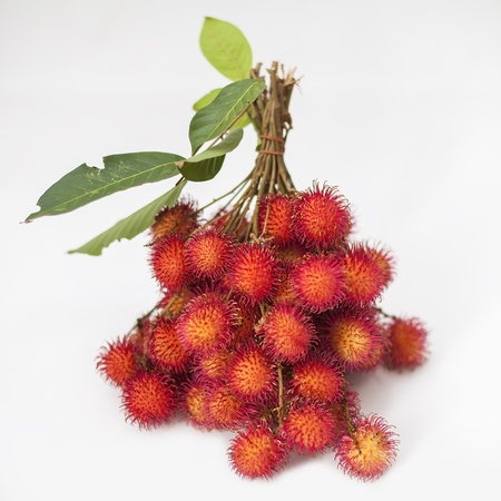 Rambutan Thai with leaves isolated background の写真素材