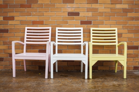 three chair with a brick wall. の写真素材