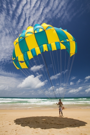 PHUKET THAILAND SEPTEMBER 15  Unidentified man prepares a parachute for tourists on the beach, on September 15, 2013 at Karon Beach in Phuket Thailand  のeditorial素材