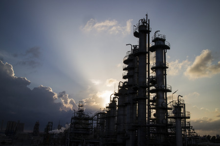 Petrochemical column and light beam in background.