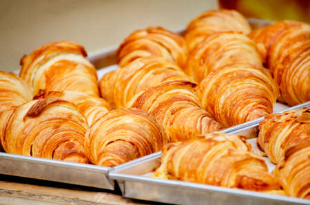 Closed up delicious croissant bakery in they tray after cooked and get out from the ovenの写真素材