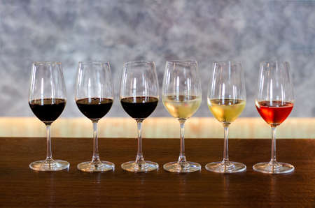 Various kinds of wine glasses on wooden table background ready to serve at the party