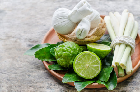 Fresh bergamot fruit and lemongrass for raw material or ingredient of Thai style harbal compress in spa shopの写真素材