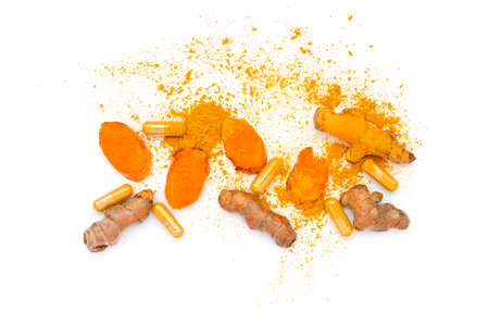 Group of organic turmeric powder spread with fresh root, sliced pieces, and capsule on white backgroundの写真素材