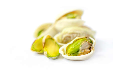 Closed up peeled roasted pistachio nut on white background. For healthy food ingredient or agricultural product conceptの写真素材