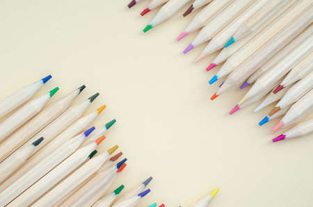 Group of light brown wooden pencil color on soft brown paper backgroundの写真素材