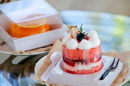 Closed up delicious sweet strawberry cake with raspberry sauce and berry fruit on top with blur...