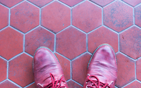 Feet concept with red shoes on black background with space for text or symbol .の写真素材