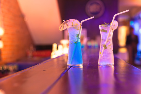 Cocktails on the bar counter in night club .の写真素材