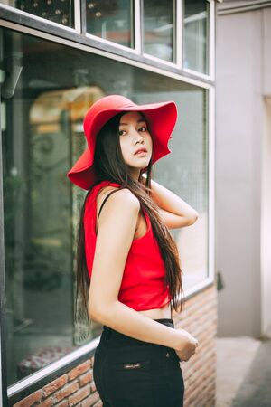 beautiful girl is posing with red suit and red hat.の写真素材