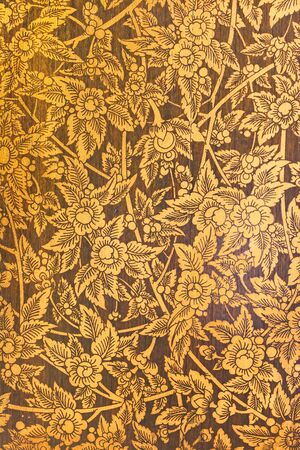 Thai culture sculpture on the wood cabinets wall at public areas temple.の写真素材