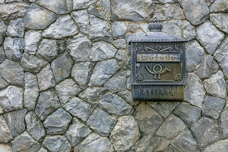 Mail box on a stone wall stone wall texture.の写真素材