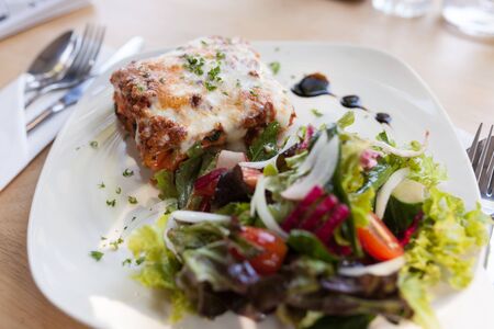 Authentic Italian Meat Lasagna with fresh salad.の写真素材