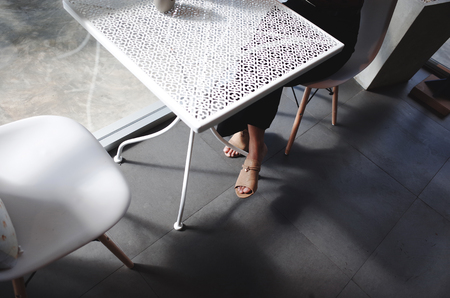 Women sit on chair In office with light and shadow.の写真素材