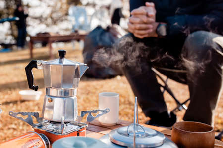 Man Preparing Coffee in a Moka Pot Outdoor.