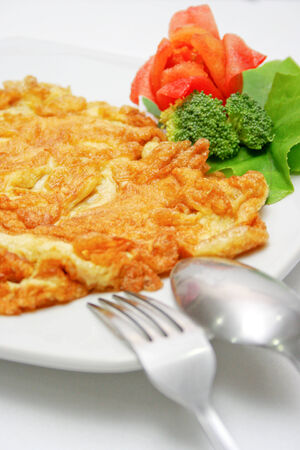 pork omelet with spoon and forkの写真素材