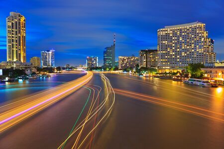 lights line of boats on the Chao Praya River at dusk , Bangkok, Thailandの写真素材