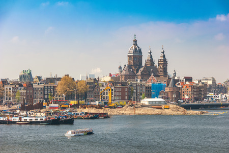Amsterdam city skyline at harbour and Basilica of Saint Nicholas, Amsterdam, Netherlandsの写真素材
