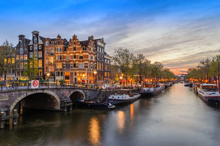 Amsterdam city skyline at canal waterfront when sunset, Amsterdam, Netherlandsの写真素材