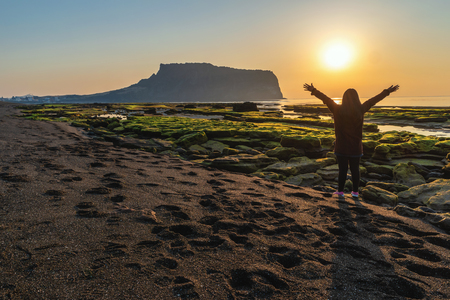 Jeju Island South Korea, Sunrise landscape at Seongsan Ilchulbong with woman touristの写真素材