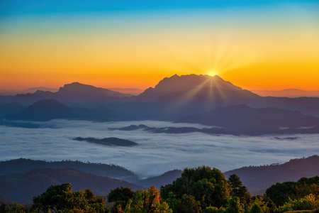 Tropical forest nature landscape view with mountain range sunrise with moving cloud mist at Huai Nam Dang National Park, Chiang Mai Thailandの写真素材