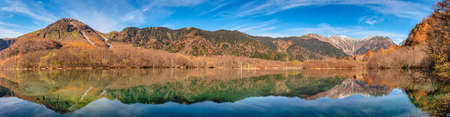 Nature landscape at Kamikochi Japan, panorama autumn fall foliage with pond and mountainの写真素材